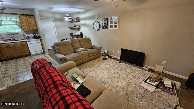 living room with ceiling fan and sink