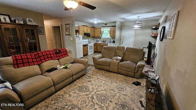 carpeted living room with ceiling fan