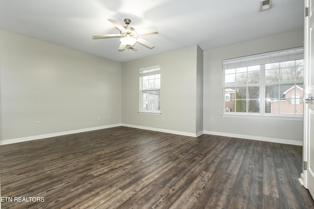 spare room with ceiling fan and dark hardwood / wood-style flooring