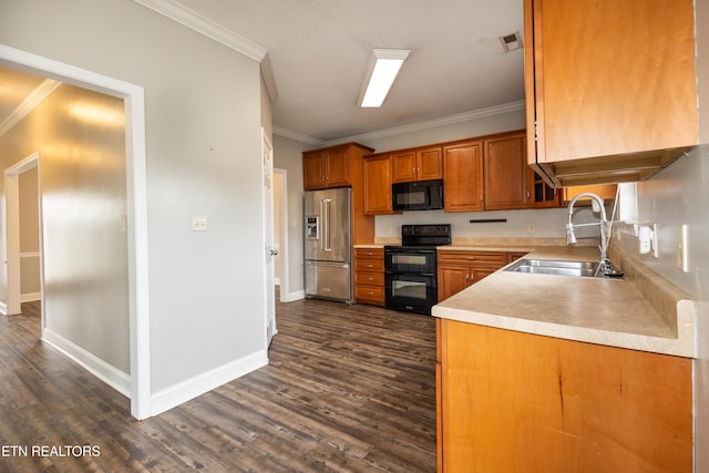 kitchen with black appliances, dark hardwood / wood-style floors, ornamental molding, and sink