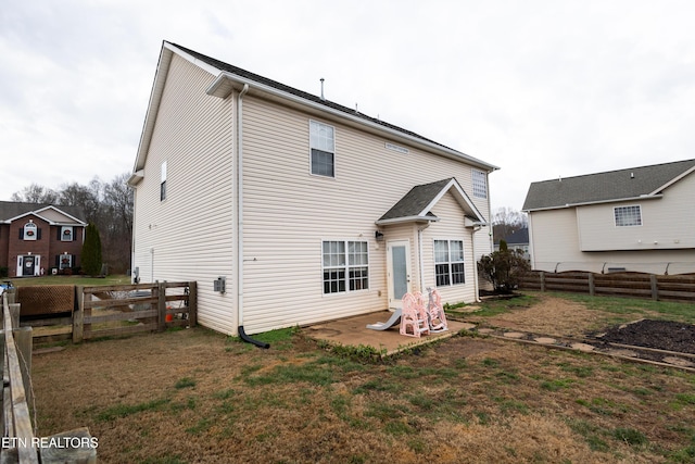 rear view of house with a yard and a patio