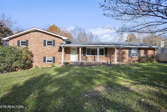 tri-level home featuring a front yard and covered porch