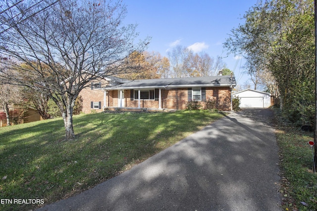 ranch-style house with a garage, a front lawn, and an outdoor structure