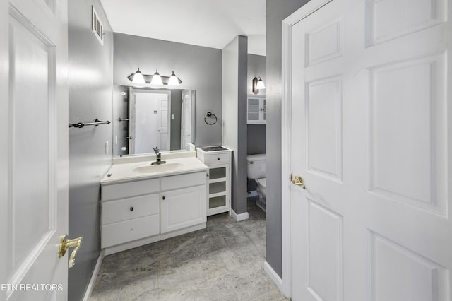 bathroom with vanity and toilet