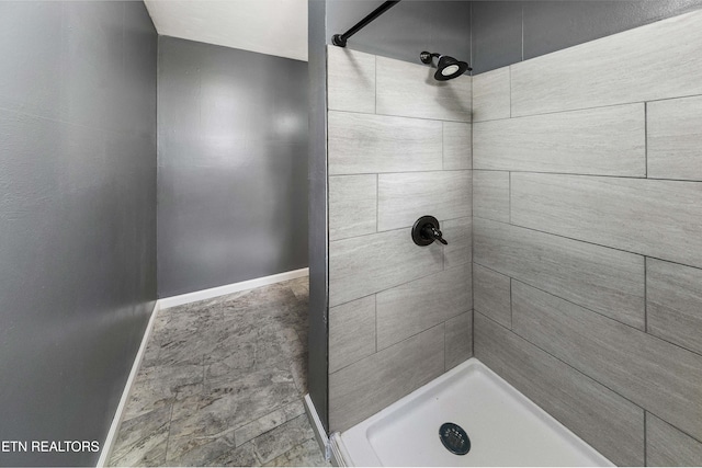 bathroom with a tile shower