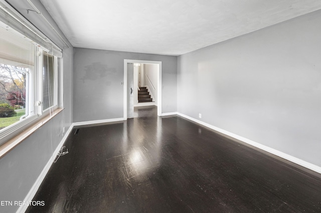 spare room with dark hardwood / wood-style flooring