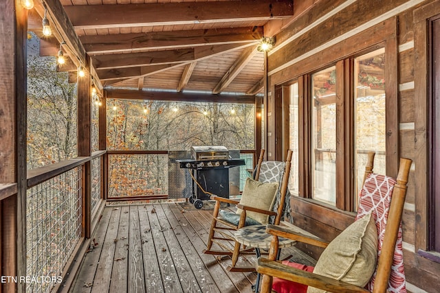 unfurnished sunroom with beam ceiling and wooden ceiling