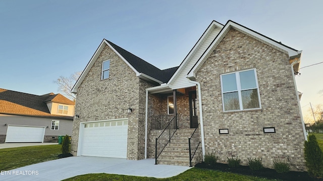 view of front of home with crawl space, brick siding, driveway, and an attached garage