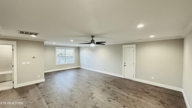 unfurnished room with a ceiling fan, baseboards, visible vents, dark wood-style floors, and crown molding