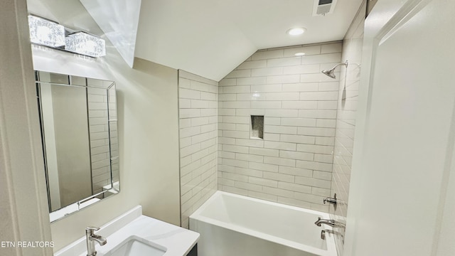 full bath with lofted ceiling, bathtub / shower combination, visible vents, and vanity