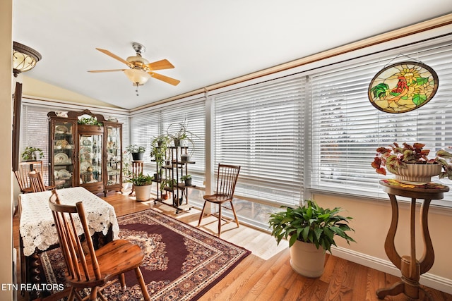 sunroom with ceiling fan and vaulted ceiling