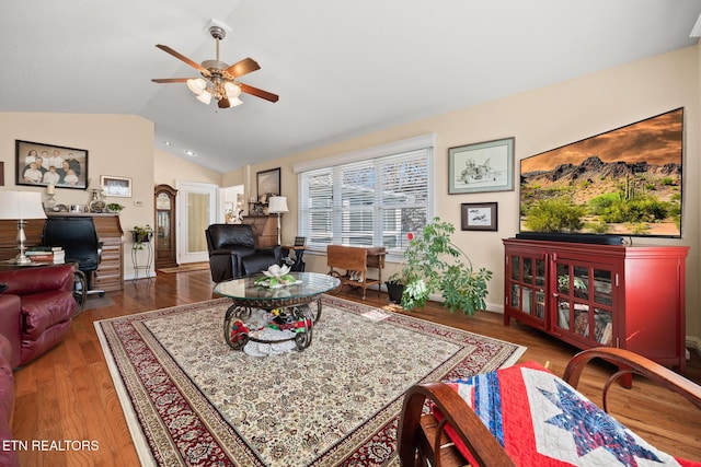 living room with ceiling fan, wood-type flooring, and lofted ceiling