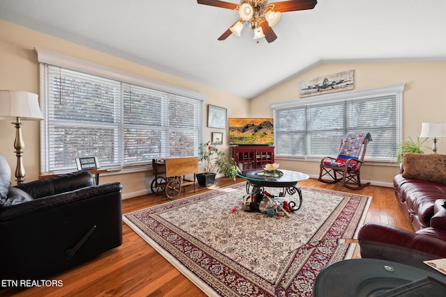 living room featuring ceiling fan, light hardwood / wood-style flooring, and vaulted ceiling