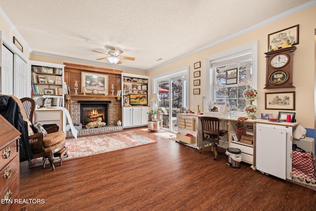 home office with ornamental molding, dark wood-type flooring, a textured ceiling, and a brick fireplace