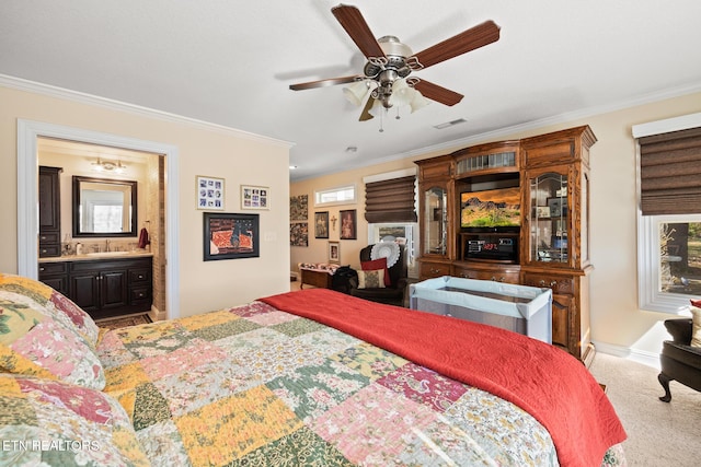 bedroom with ensuite bath, ceiling fan, crown molding, and carpet