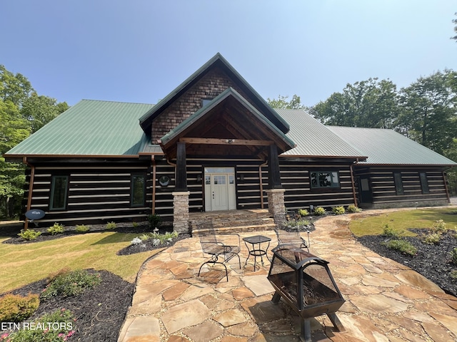 625 Cane Creek Mountain Rd, Tellico Plains, TN 37385 - rear view of house with a patio area, metal roof, log exterior, and a yard