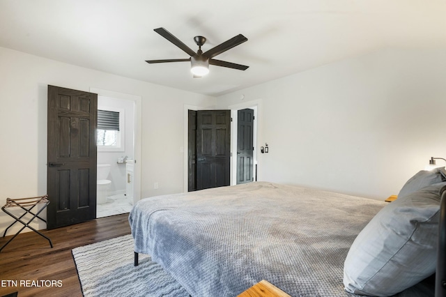 bedroom featuring dark wood-style floors, connected bathroom, and a ceiling fan