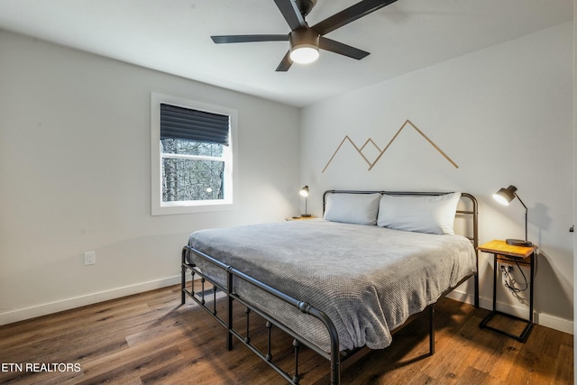 bedroom with ceiling fan, dark wood-style flooring, and baseboards