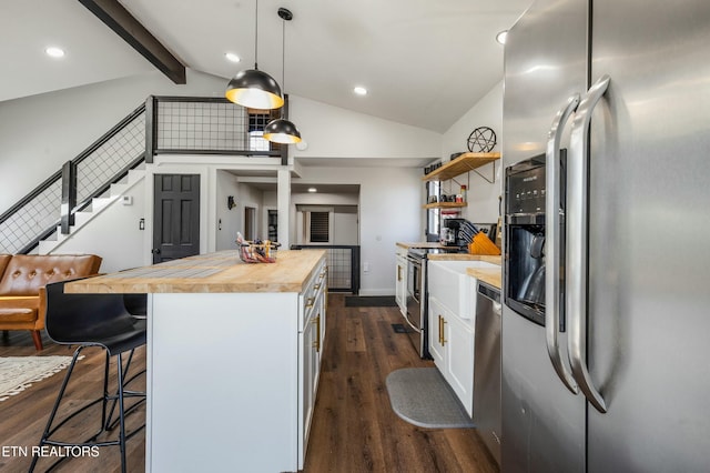 kitchen featuring stainless steel appliances, white cabinetry, wooden counters, open shelves, and decorative light fixtures