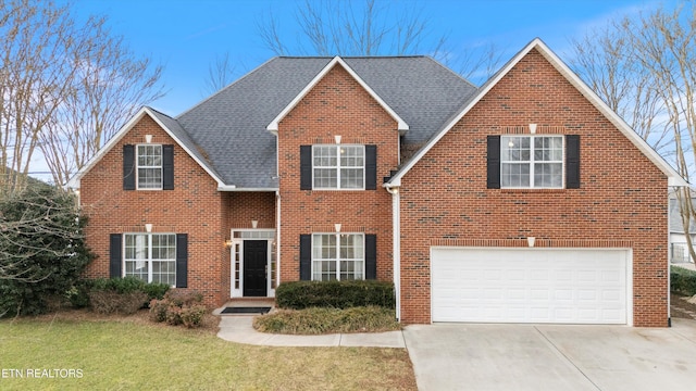 view of front of home featuring a garage and a front lawn