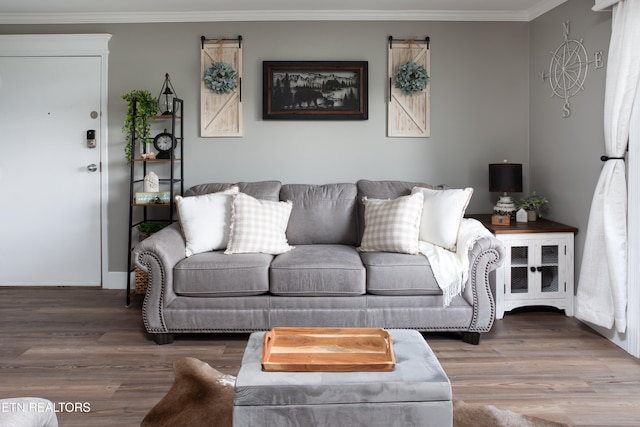 living room with hardwood / wood-style floors and crown molding