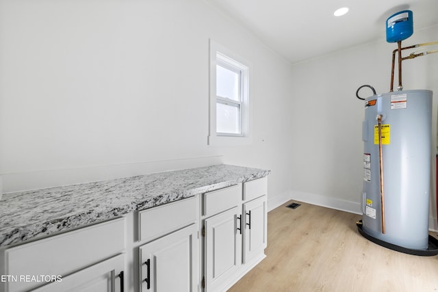 utility room with electric water heater