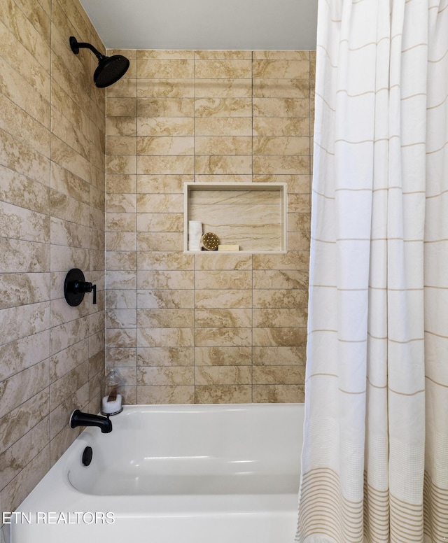 bathroom featuring shower / bathtub combination with curtain