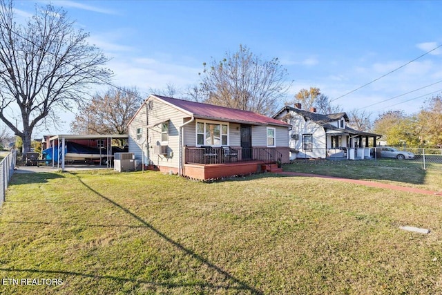 view of front of house with central AC unit, a carport, and a front yard