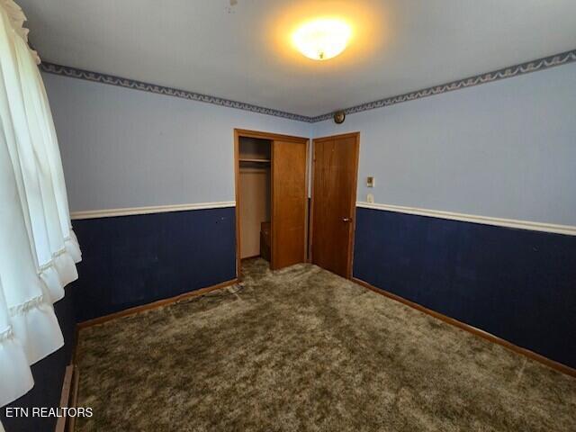 unfurnished bedroom featuring a closet and carpet flooring