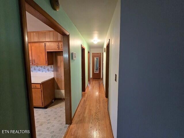 corridor with light wood-style floors