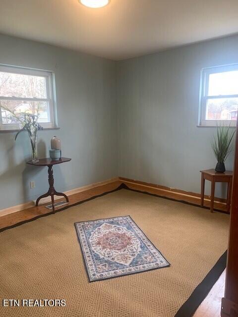 interior space featuring a healthy amount of sunlight and baseboards