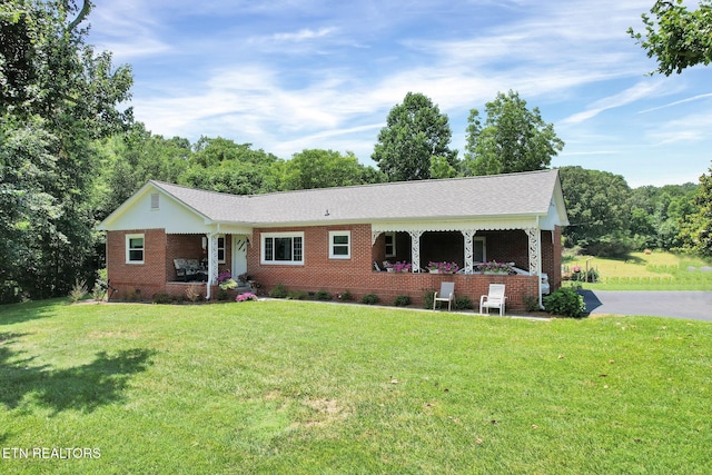 single story home featuring a porch and a front yard