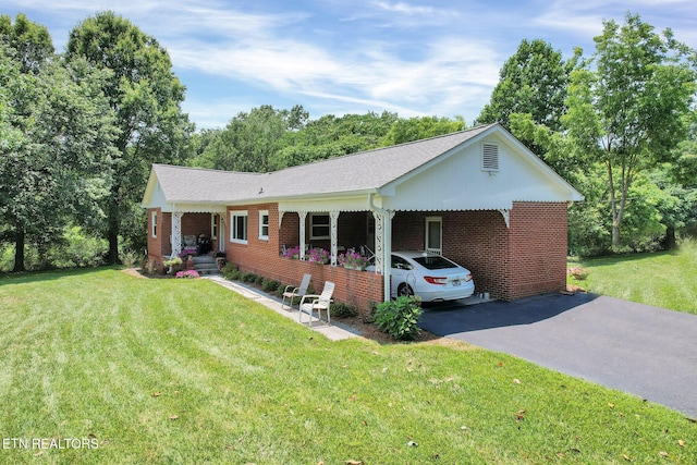 single story home featuring a front yard and a carport