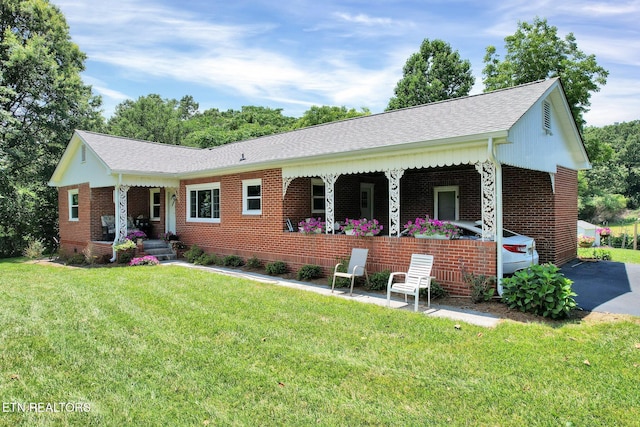 ranch-style home with a porch and a front yard