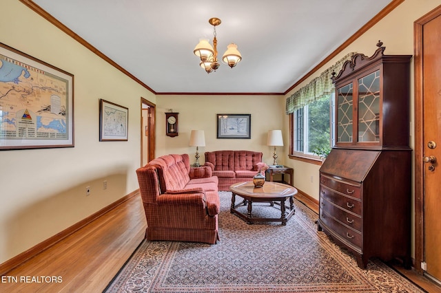 living room with wood-type flooring, an inviting chandelier, and crown molding