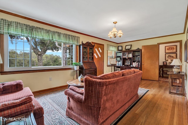 living room with a notable chandelier, light hardwood / wood-style floors, and ornamental molding