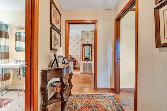 corridor with light hardwood / wood-style floors