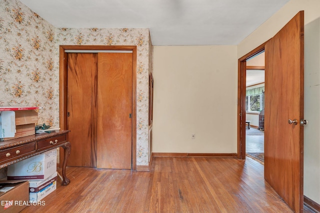 bedroom featuring light wood-type flooring and a closet