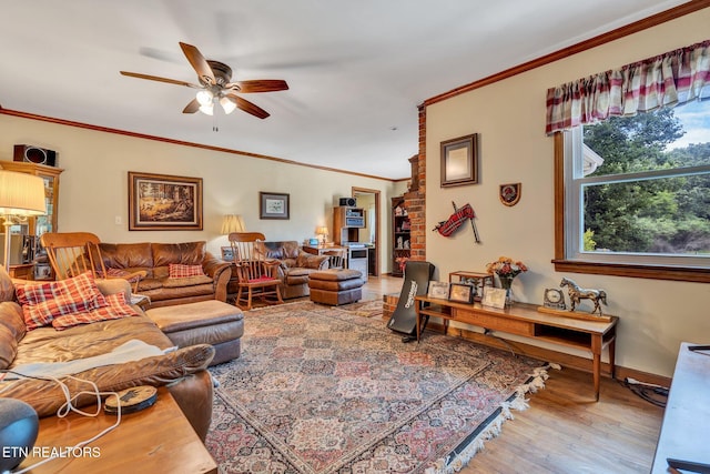 living room featuring hardwood / wood-style flooring, ceiling fan, and crown molding