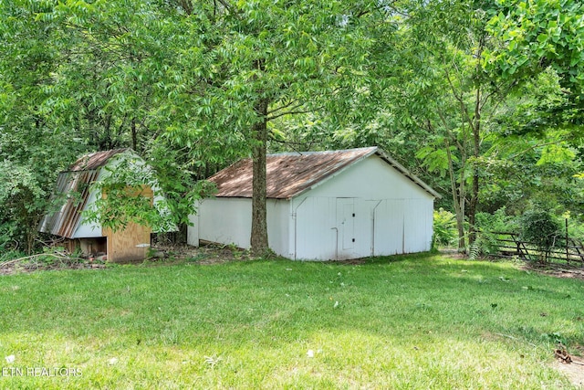 view of outbuilding featuring a yard