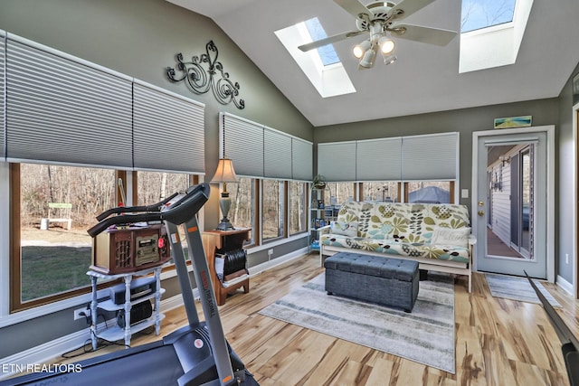 workout room with light hardwood / wood-style flooring, ceiling fan, and lofted ceiling