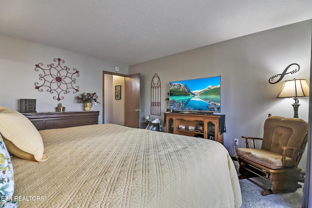 carpeted bedroom featuring a textured ceiling