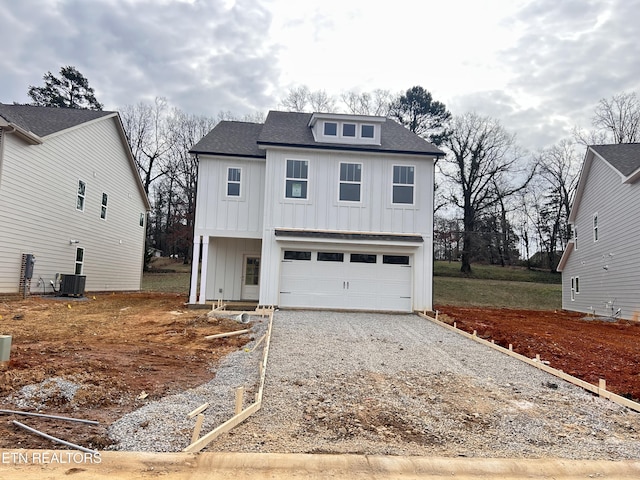 view of front of home with a garage and cooling unit