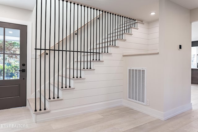 stairway with hardwood / wood-style floors