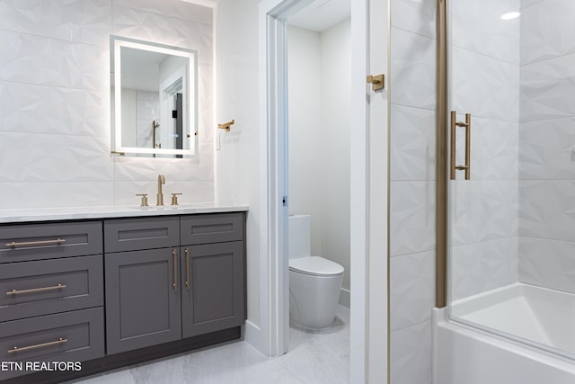 bathroom featuring vanity, toilet, tile walls, and backsplash