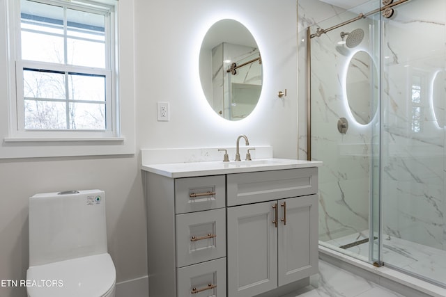 bathroom with vanity, toilet, and a shower with shower door