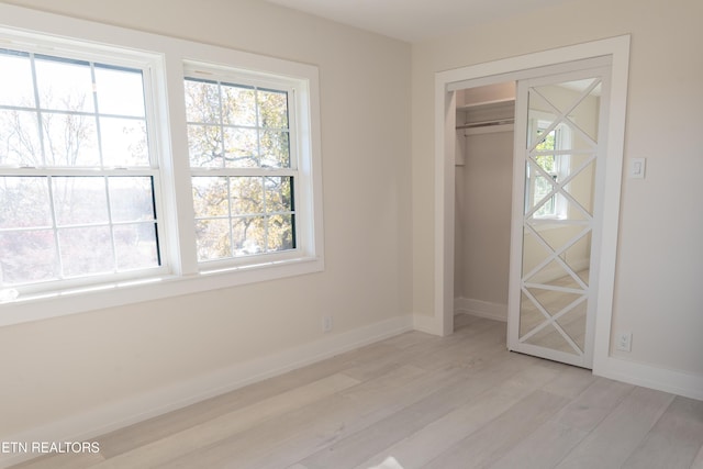 12000 S Fox Den Dr, Knoxville, TN 37934 - unfurnished bedroom featuring light wood-style floors, multiple windows, and a closet