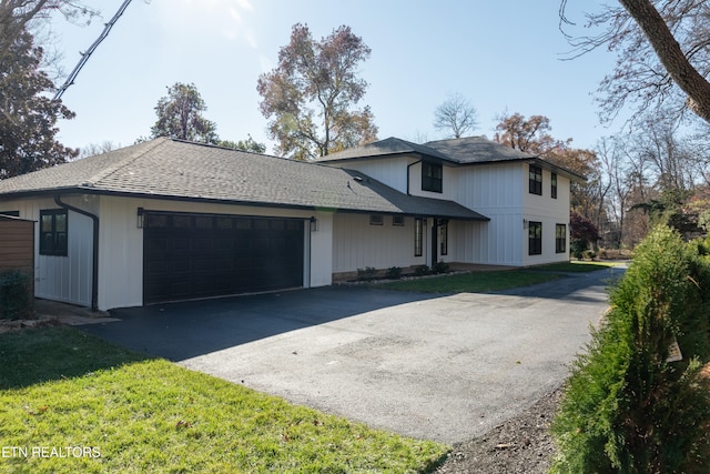 view of front of house featuring a garage and a front lawn