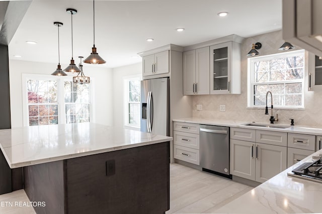 12000 S Fox Den Dr, Knoxville, TN 37934 - kitchen with appliances with stainless steel finishes, light stone countertops, a center island, backsplash, and glass insert cabinets