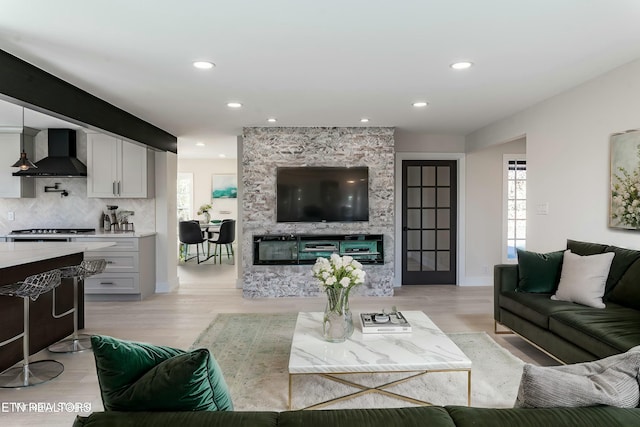 living room with plenty of natural light and light hardwood / wood-style floors